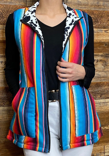 Serape/Cow printed reversible zipper vest w pockets.